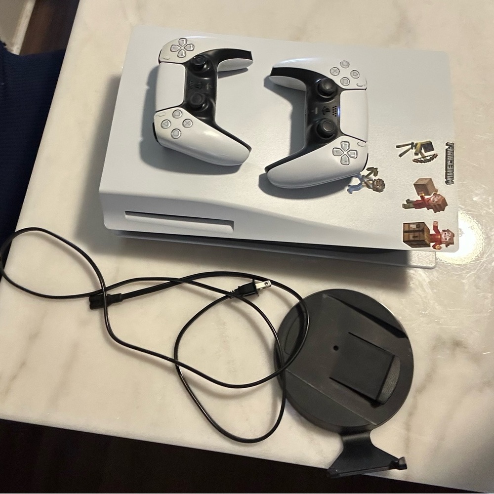 White and Black PlayStation 5 Console with DualSense Controllers